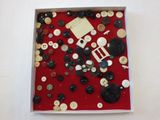 a picture of a box of buttons on a table