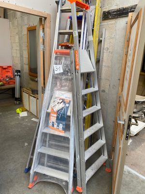 a ladder that is standing in a room with a ladder
