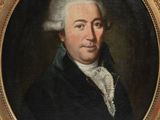 portrait of a man in a black coat and white hair