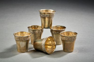 six silver cups sitting on top of each other on a table
