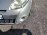 a close up of a car ' s headlight on a parking lot