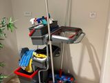 a mop, buckets, and other cleaning supplies on a cart