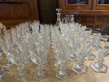 many wine glasses sitting on a table in a room