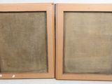 a pair of two wooden framed pictures of a man and a woman