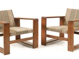 pair of wooden chairs with upholstered upholstered cushions