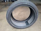 a close up of a tire on the ground in a garage