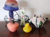 a table with a lamp, a vase, and a picture frame on it