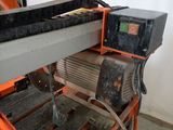 a machine that is cutting a piece of metal on a table
