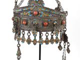 an image of a silver and multicolored crown on a stand