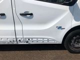 a white van that has been painted white and has holes on the side of it