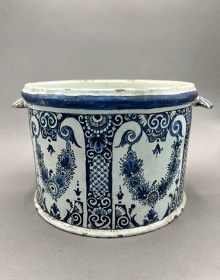 an image of a blue and white planter with floral designs on it