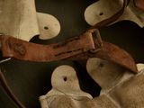 a brown leather belt and a pair of shoes on a table