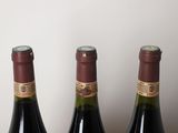 three bottles of wine that are sitting on a table
