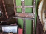 a pile of old frames and pictures on the floor