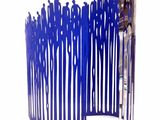 a blue sculpture of a group of people standing in front of a fence