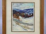 un tableau représentant un paysage enneigé, dans un cadre en bois