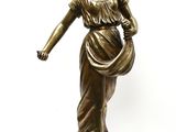 bronze statue of a woman with a basket on her head