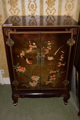 a cabinet that has a bird and flowers design on it