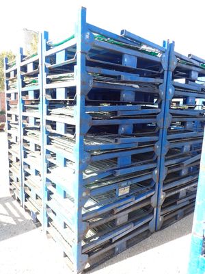 a large stack of pallets sitting on the side of the road
