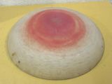 a red spot on the top of a white object