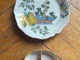 a small plate with a bird on it next to a small plate with a bird on it