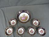 six plates and a bowl with a picture of a woman on them