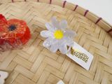 a basket with a flower on it and a tag on it