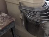 a mixer that is sitting in a kitchen next to a table