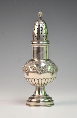 a silver salt and pepper shaker sitting on a table