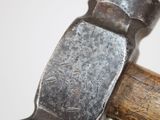 a hammer with a wooden handle on a white surface