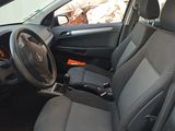 the interior of a car with black seats and a steering wheel