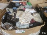 a cardboard box filled with clothes and other items