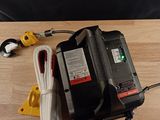 a picture of a cord and a battery on a wooden table