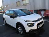the white citrole is parked in front of a building