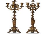 pair of antique brass candelabs with figures on each of them