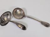 two spoons that are sitting next to each other on a table