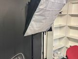 a photo studio with a chair and a light in it