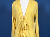 a woman ' s yellow cardigan sweater on a mannequin mannequin mannequin mannequin mannequin mannequin mannequin mann