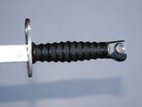 a close up of a knife with a black handle