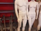 three mannequins that are standing in a room