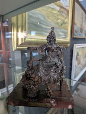 une statue représentant un homme à cheval, exposée dans une vitrine