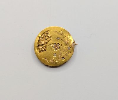 a close up of a gold coin on a white surface