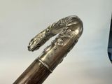 a close up of a cane with a dragon head on it