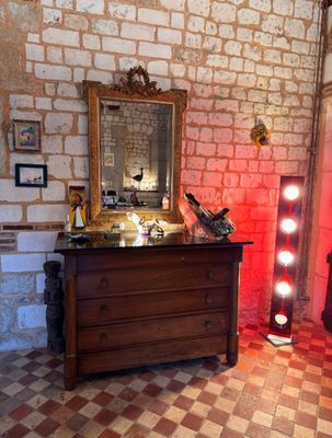 a dresser and a mirror in a room with a checkered floor