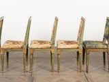 four chairs with a floral upholstered back and a floral upholstered back