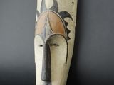 an image of a wooden sculpture of a man ' s face