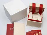 a white box with a red ribbon around it and a red credit card in it