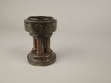 an old wooden candle holder on a white surface