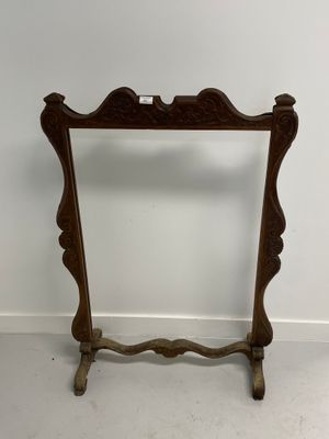 a wooden frame with a mirror on top of it in a room
