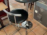 a black table and two chairs in a restaurant